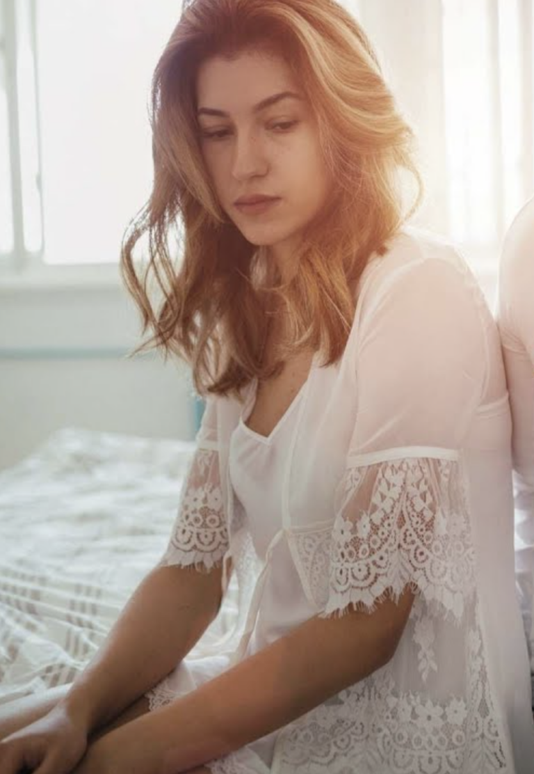 Nő az ágyon elgondolkodva - miért fájhat a szex